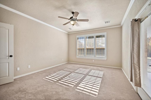 carpeted empty room featuring crown molding, visible vents, a textured wall, a textured ceiling, and baseboards