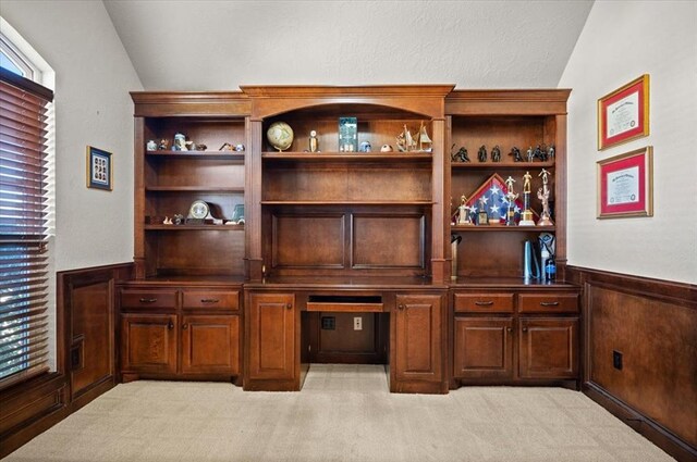 bar with lofted ceiling, wainscoting, light colored carpet, and wooden walls