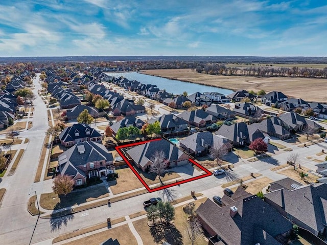 drone / aerial view featuring a water view and a residential view