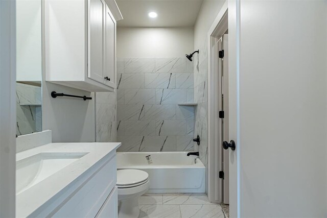 full bathroom with tiled shower / bath combo, vanity, and toilet