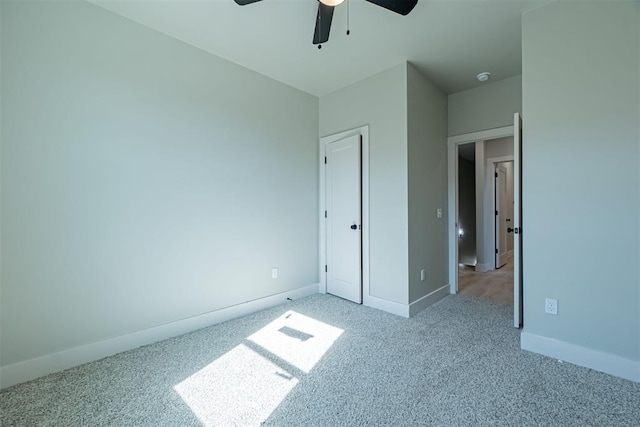 unfurnished bedroom featuring light carpet and ceiling fan