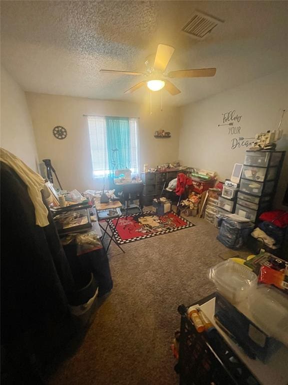 interior space featuring ceiling fan and a textured ceiling