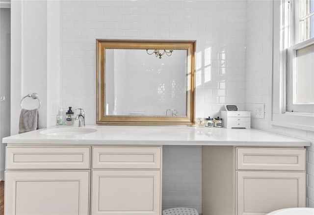 bathroom featuring vanity and tile walls