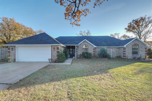 ranch-style home featuring a front yard and a garage