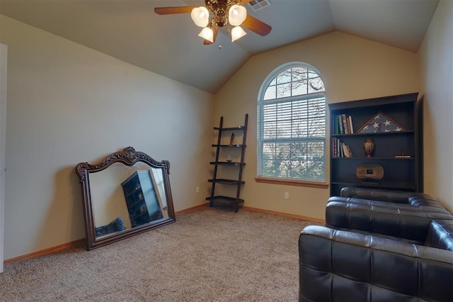 living area with ceiling fan, carpet floors, and lofted ceiling