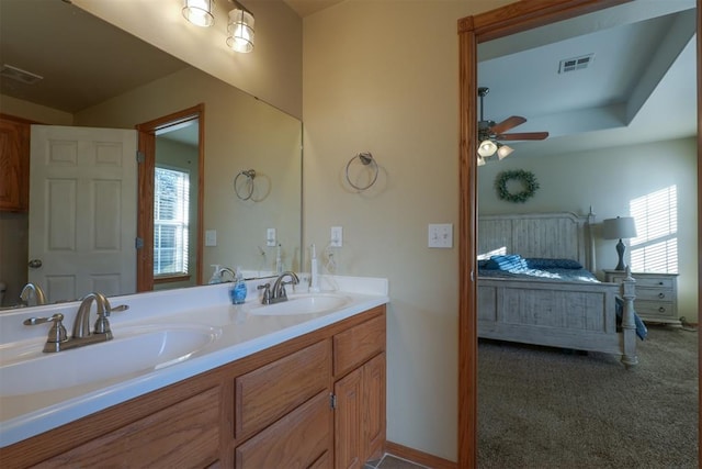 bathroom with vanity, a wealth of natural light, and ceiling fan