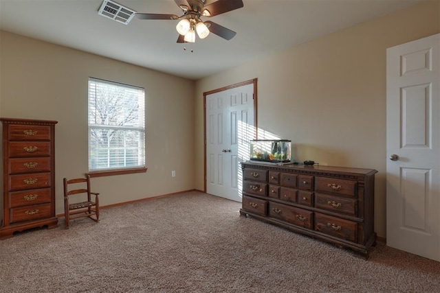 carpeted bedroom featuring a closet and ceiling fan