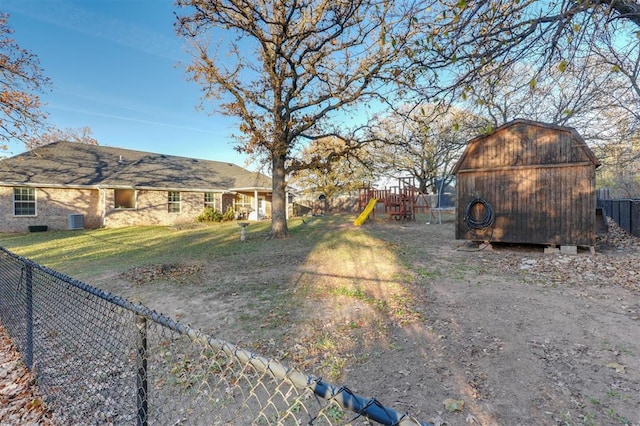 view of yard featuring cooling unit, a shed, and a playground