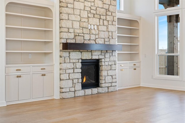 417 Basin Way, Norman, OK 73069 - unfurnished living room featuring a fireplace, light wood finished floors, baseboards, and built in features