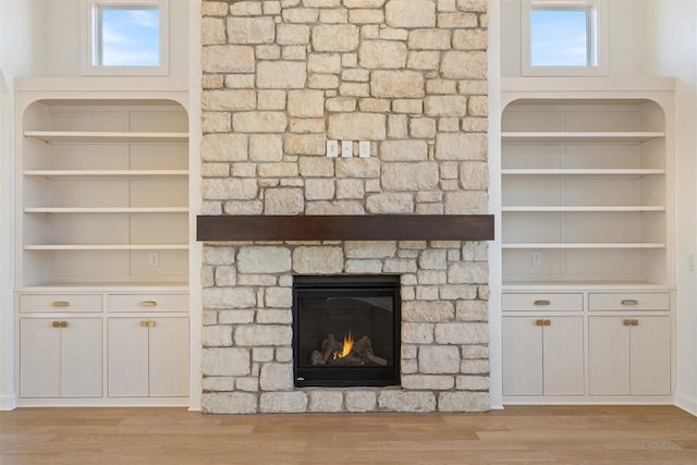 417 Basin Way, Norman, OK 73069 - detailed view of a stone fireplace, wood finished floors, and built in shelves