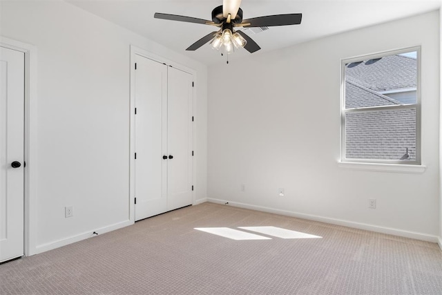 417 Basin Way, Norman, OK 73069 - unfurnished bedroom with light carpet, baseboards, and a ceiling fan