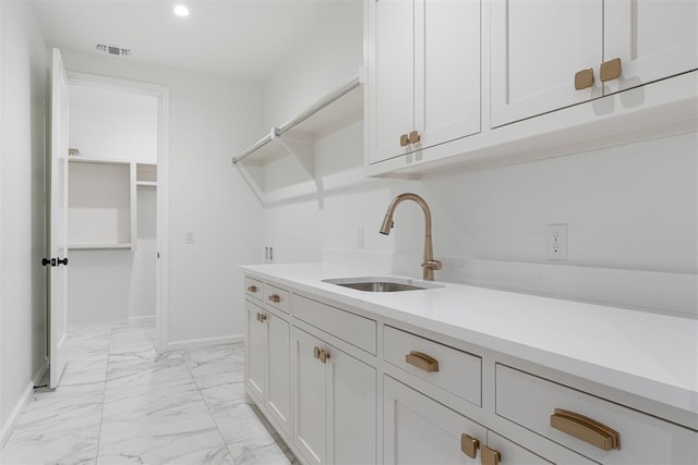 417 Basin Way, Norman, OK 73069 - laundry room with a sink, light marble finish floors, baseboards, and recessed lighting