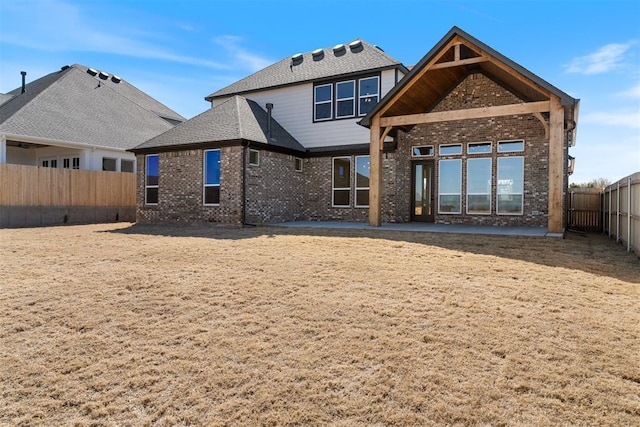 417 Basin Way, Norman, OK 73069 - rear view of property featuring brick siding, a fenced backyard, and a patio area