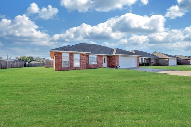 ranch-style house featuring a garage and a front yard