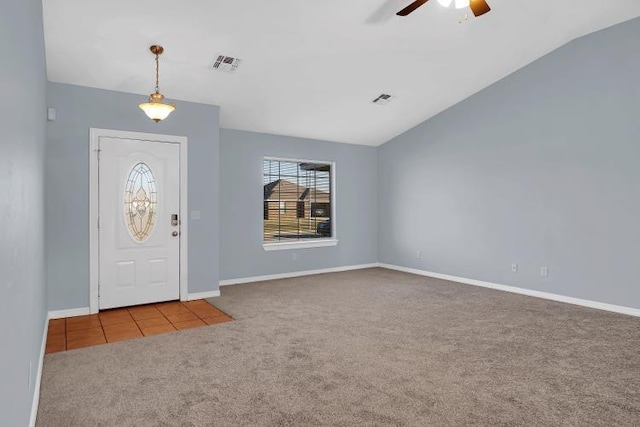 carpeted foyer entrance with vaulted ceiling and ceiling fan