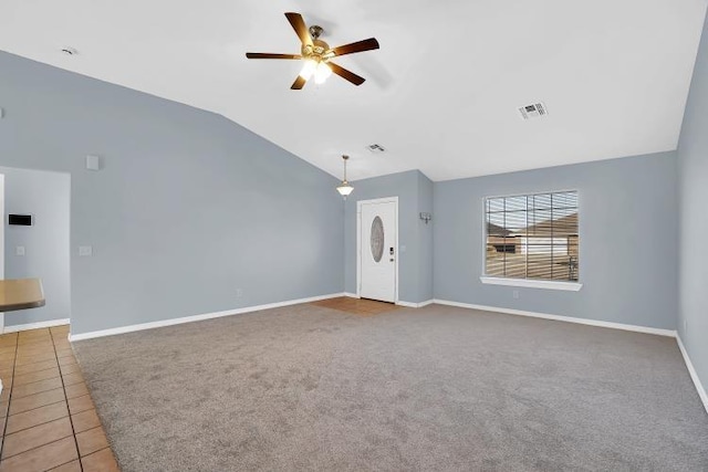 unfurnished living room with tile patterned flooring, ceiling fan, and vaulted ceiling