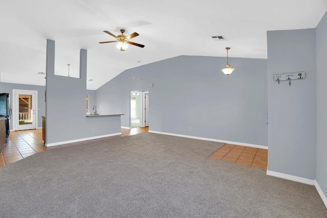 unfurnished living room featuring ceiling fan, carpet, and lofted ceiling