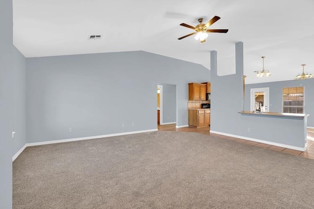 unfurnished living room with light carpet, ceiling fan with notable chandelier, and lofted ceiling