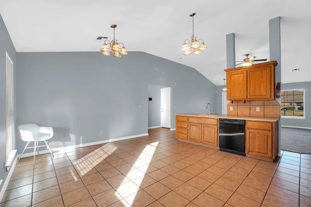 kitchen featuring dishwasher, ceiling fan with notable chandelier, light tile patterned flooring, and lofted ceiling