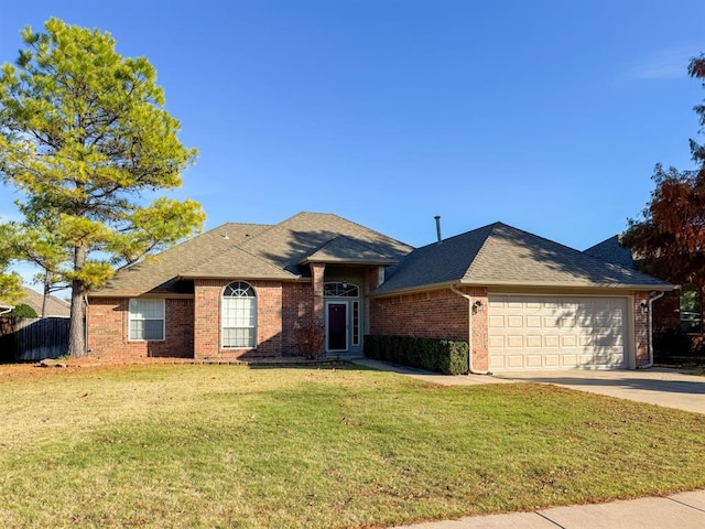 ranch-style home with a front yard and a garage