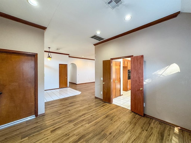 unfurnished room featuring light hardwood / wood-style flooring and crown molding