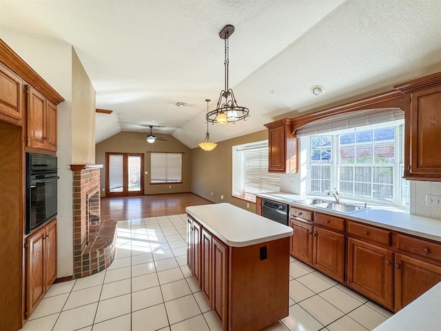 kitchen featuring black appliances, ceiling fan, a healthy amount of sunlight, and sink