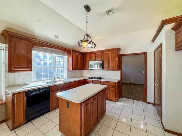 kitchen with black appliances, a center island, light tile patterned flooring, and hanging light fixtures