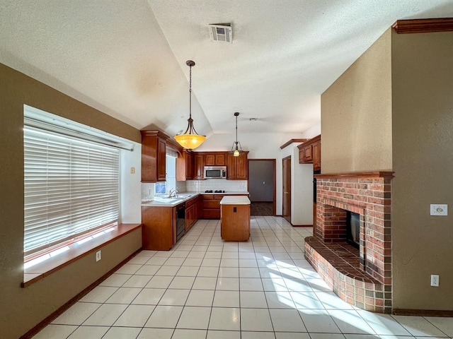 kitchen featuring dishwasher, sink, pendant lighting, lofted ceiling, and a kitchen island