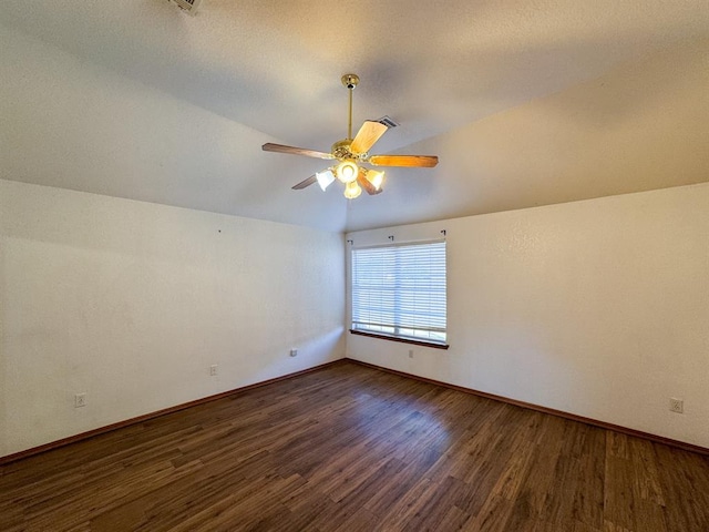 empty room with dark hardwood / wood-style floors, ceiling fan, and lofted ceiling