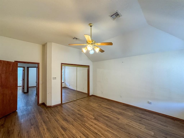 interior space featuring ceiling fan, dark wood-type flooring, and vaulted ceiling