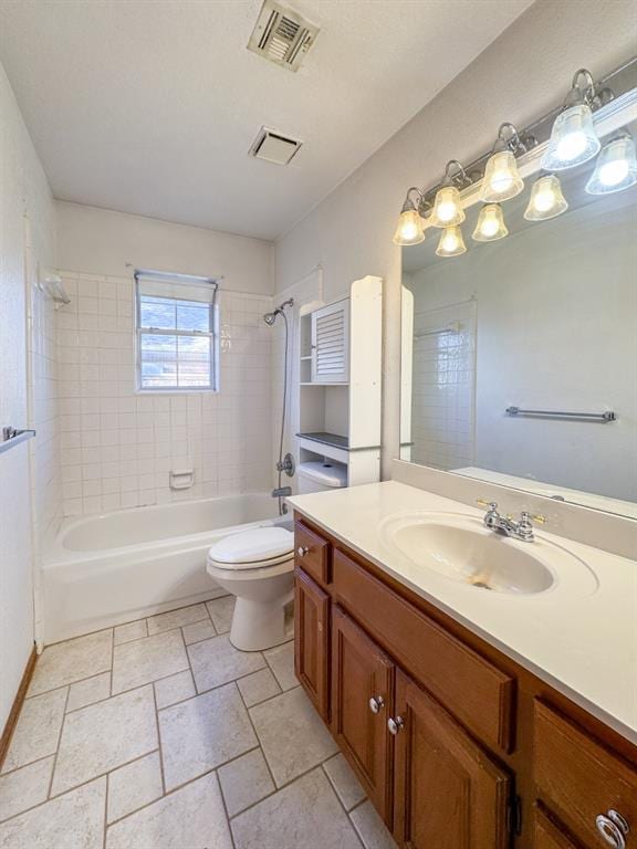 full bathroom featuring vanity, tiled shower / bath combo, and toilet