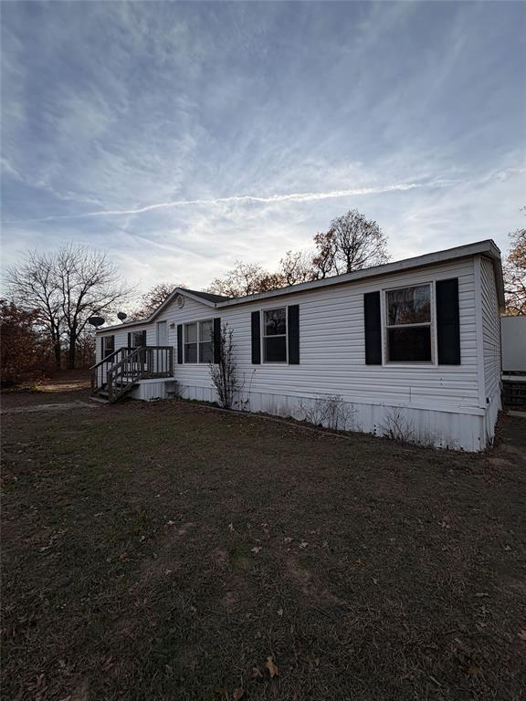 view of property exterior with a yard