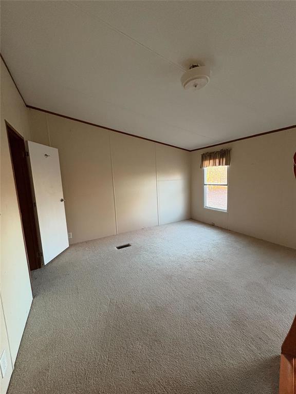 empty room featuring light colored carpet