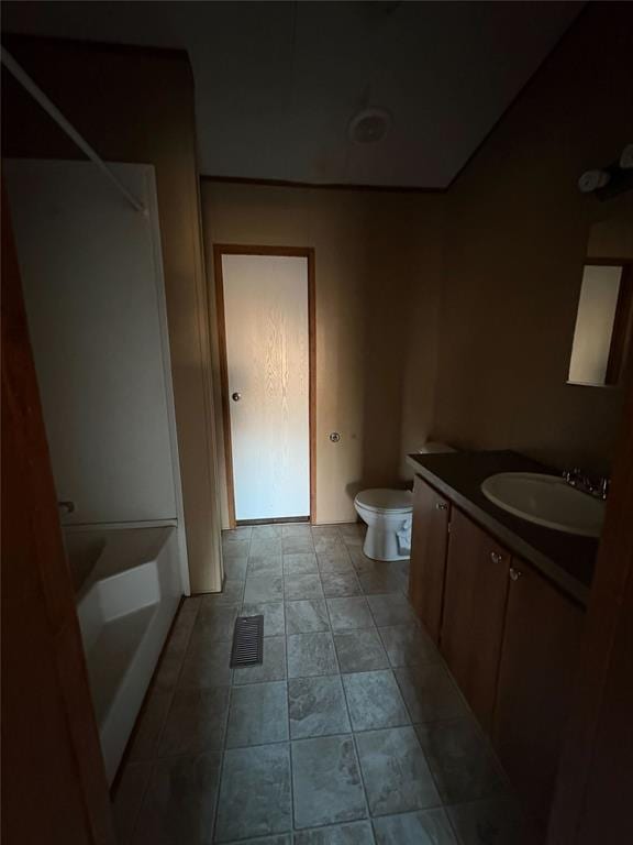 bathroom with tile patterned floors, vanity, and toilet