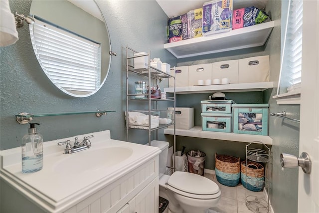 bathroom featuring toilet, tile patterned flooring, and vanity