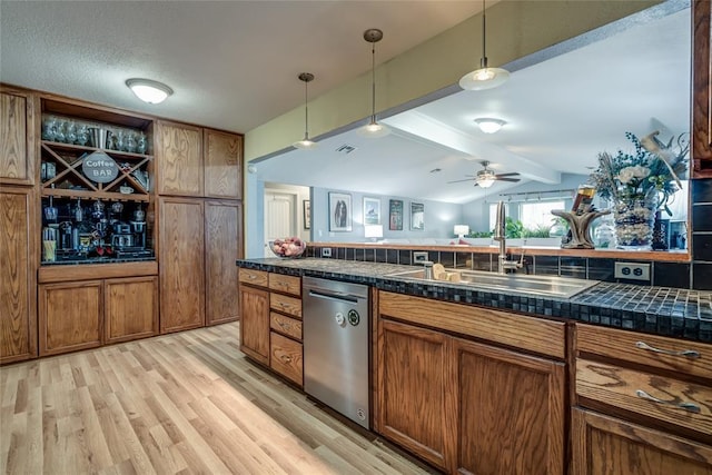 kitchen with ceiling fan, sink, stainless steel dishwasher, and decorative light fixtures