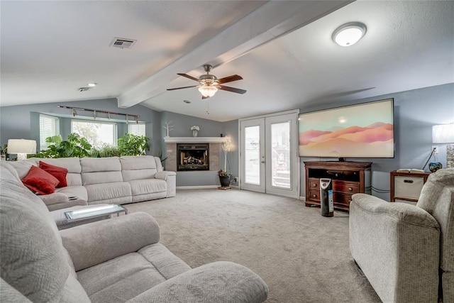 living room with ceiling fan, light carpet, french doors, and vaulted ceiling with beams