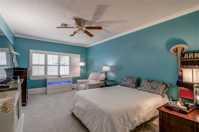 carpeted bedroom with ceiling fan and crown molding