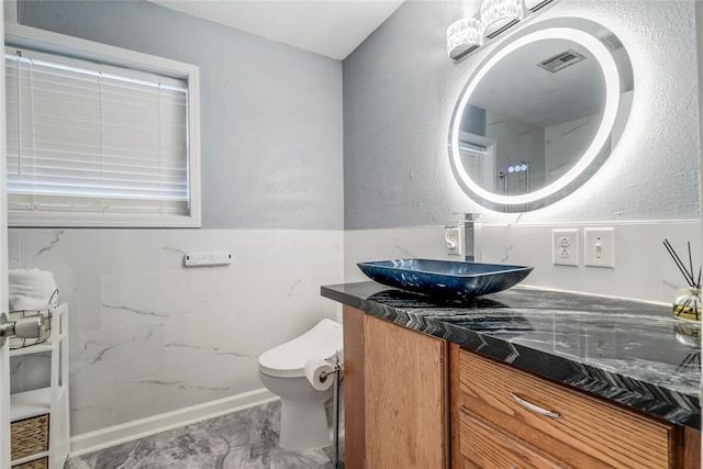 bathroom featuring toilet and vanity