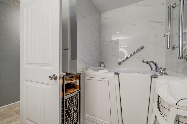 bathroom featuring a tub to relax in