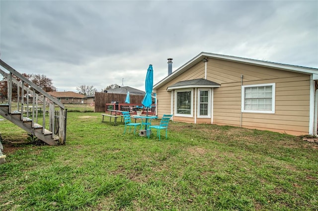 rear view of property with a yard