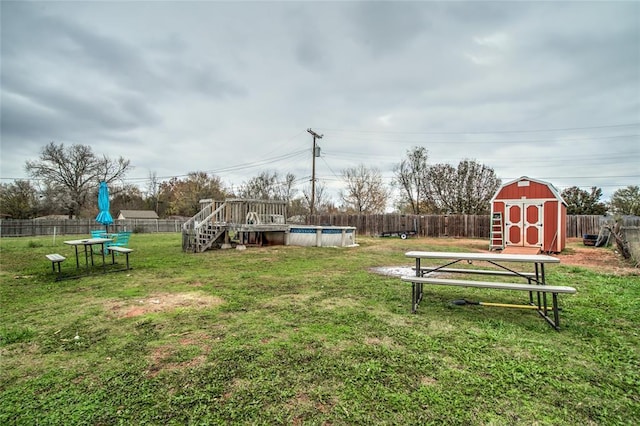 view of yard featuring a shed and a swimming pool side deck