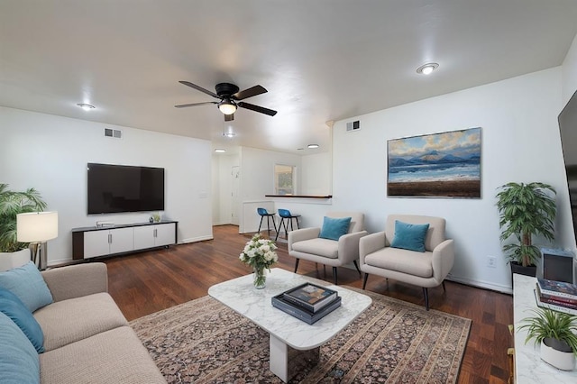 living room featuring dark hardwood / wood-style floors and ceiling fan