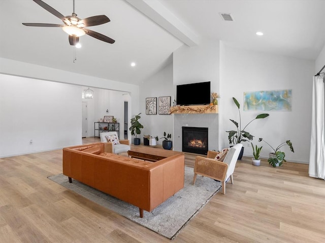 living room featuring beamed ceiling, light hardwood / wood-style floors, ceiling fan with notable chandelier, and high vaulted ceiling