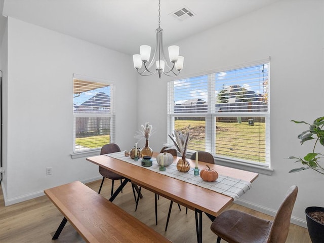 dining space featuring a chandelier and light wood-type flooring