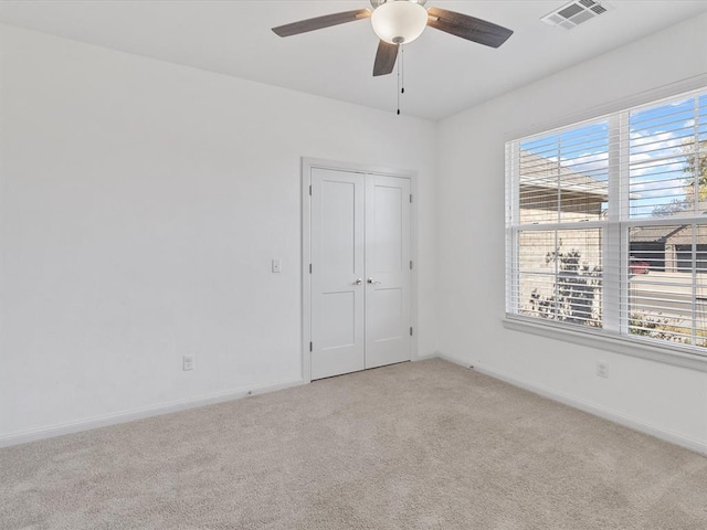 empty room with light carpet and ceiling fan