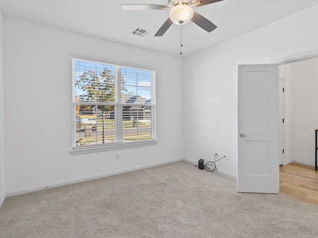 unfurnished room featuring ceiling fan and light colored carpet