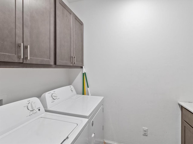 laundry area with cabinets and independent washer and dryer