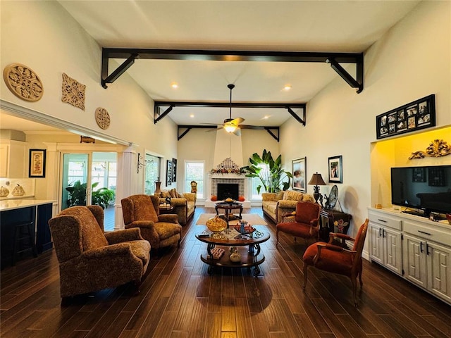 living room featuring ceiling fan, beam ceiling, and dark wood-type flooring