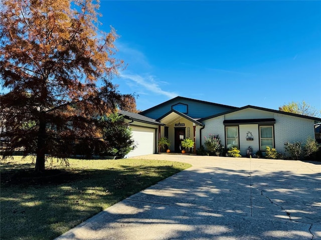 ranch-style home featuring a garage and a front yard